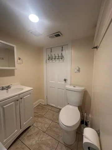 a bathroom with a toilet sink and vanity