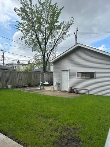a backyard of a house with table and sofas