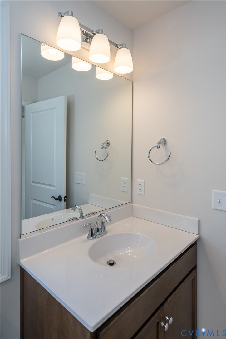 11219 Sparwood Road Chester, VA 23831 - Photo 11 of 28 a bathroom with a sink vanity and a mirror