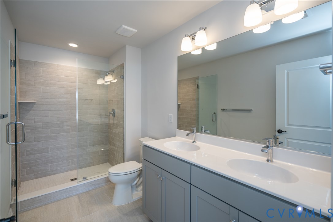 11219 Sparwood Road Chester, VA 23831 - Photo 14 of 28 a bathroom with a double vanity sink toilet and shower