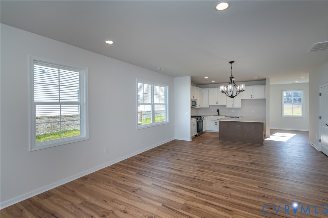 11219 Sparwood Road Chester, VA 23831 - Photo 4 of 28 an empty room with wooden floor and windows