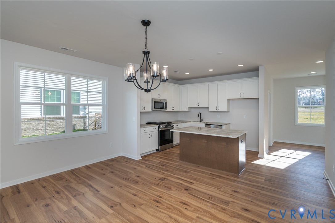 11219 Sparwood Road Chester, VA 23831 - Photo 5 of 28 a large kitchen with stainless steel appliances granite countertop a oven and a wooden floors