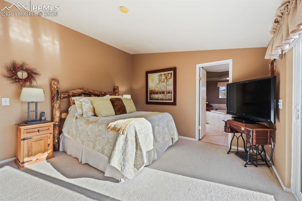 7260 Remington Road Como, CO 80432 - Photo 20 of 46 a bedroom with a bed and a flat screen tv