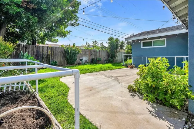 a view of a backyard with plants and a small yard