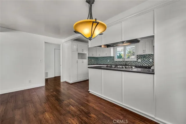 a view of a kitchen counter space and wooden floor