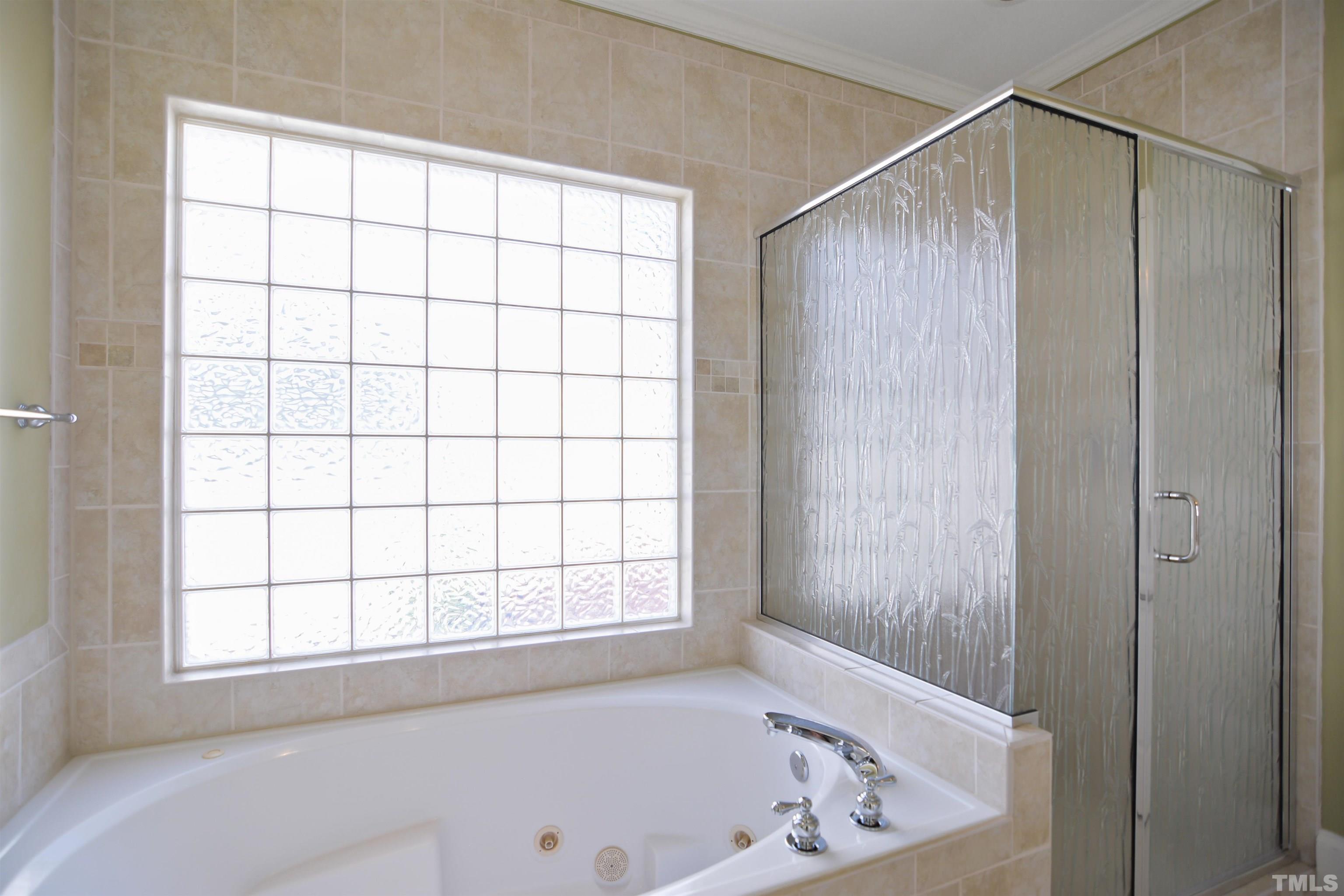 900 Tanworth Drive Raleigh, NC 27615 - Photo 12 of 26 a bathroom with a bathtub and window