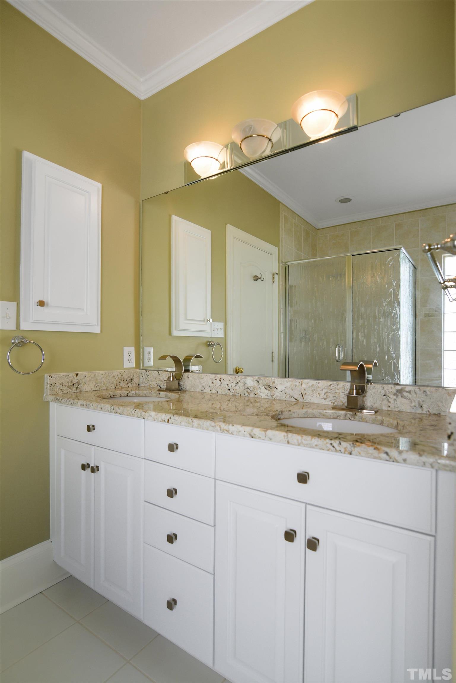 900 Tanworth Drive Raleigh, NC 27615 - Photo 13 of 26 a bathroom with a granite countertop sink and a mirror