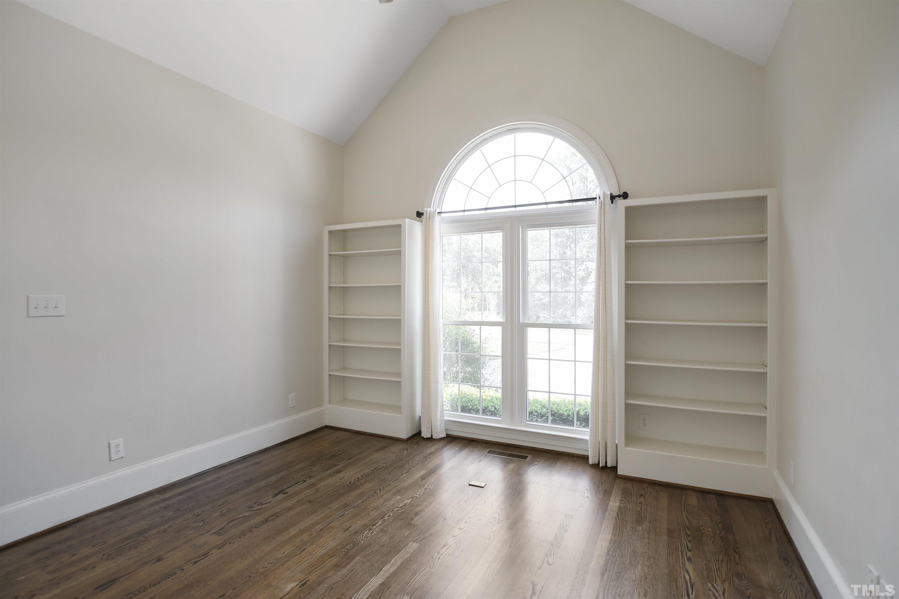 900 Tanworth Drive Raleigh, NC 27615 - Photo 14 of 26 an empty room with wooden floors and window