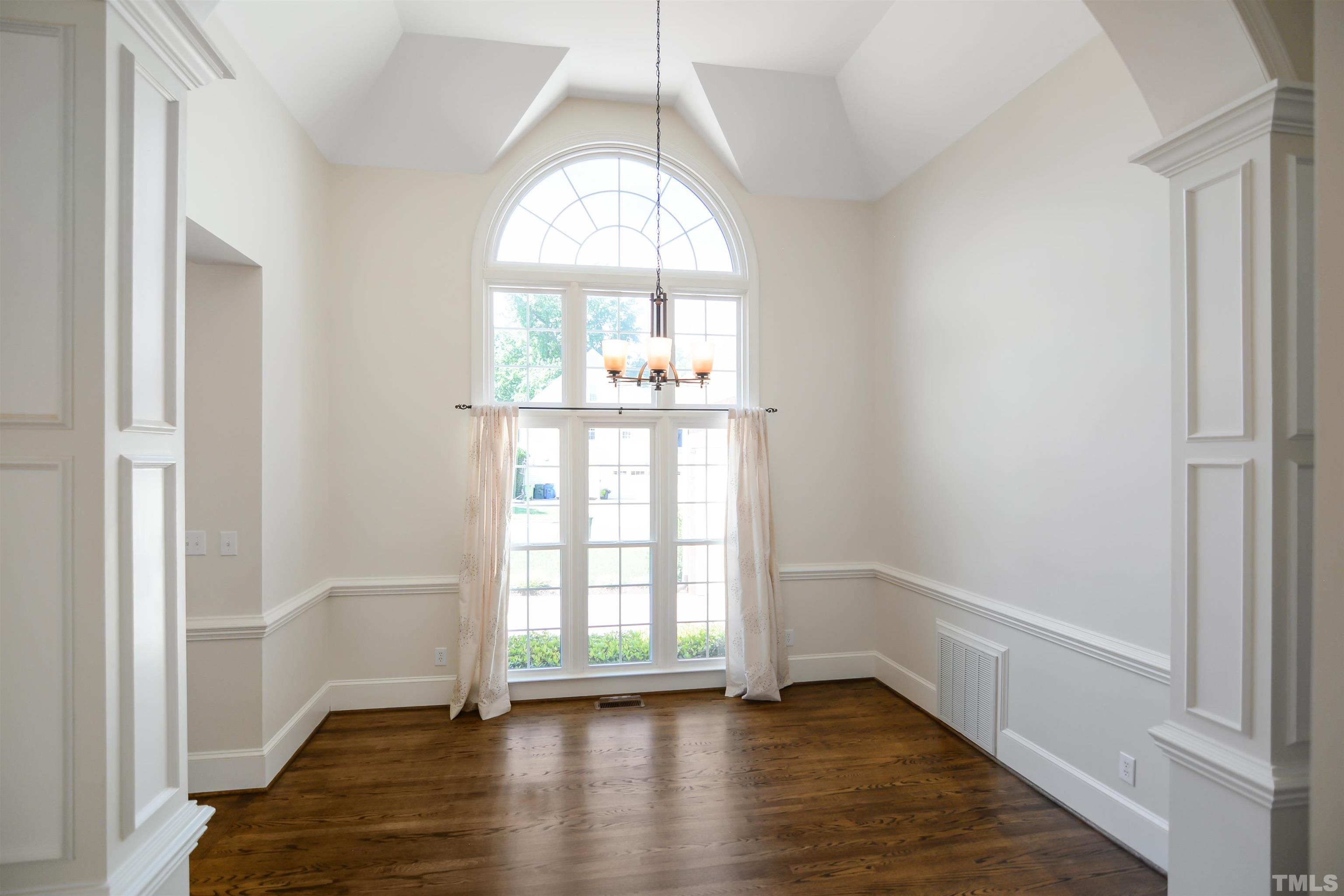 900 Tanworth Drive Raleigh, NC 27615 - Photo 3 of 26 a view of an empty room with wooden floor and a window