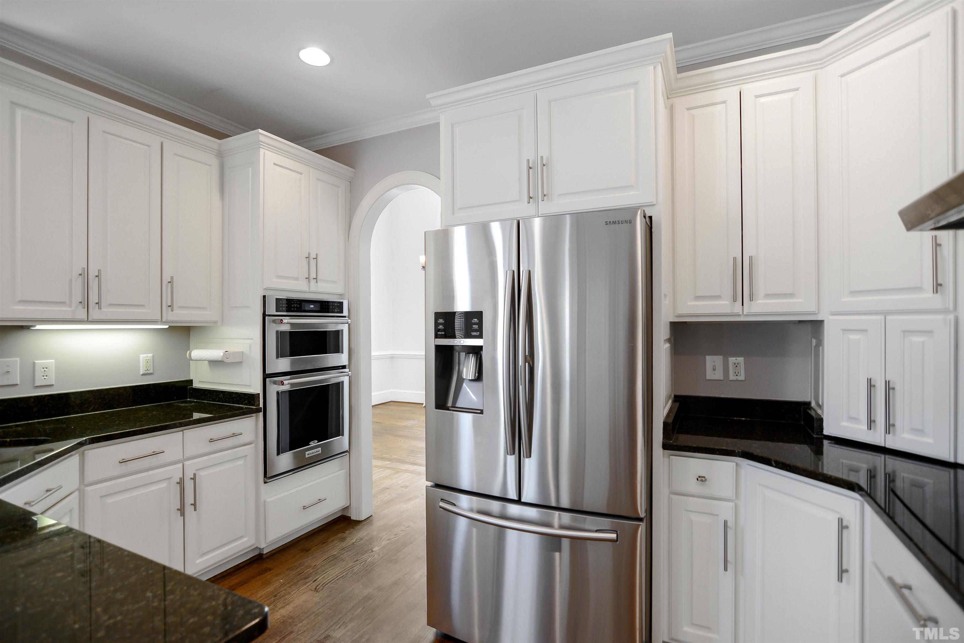 900 Tanworth Drive Raleigh, NC 27615 - Photo 7 of 26 a kitchen with stainless steel appliances white cabinets and a refrigerator