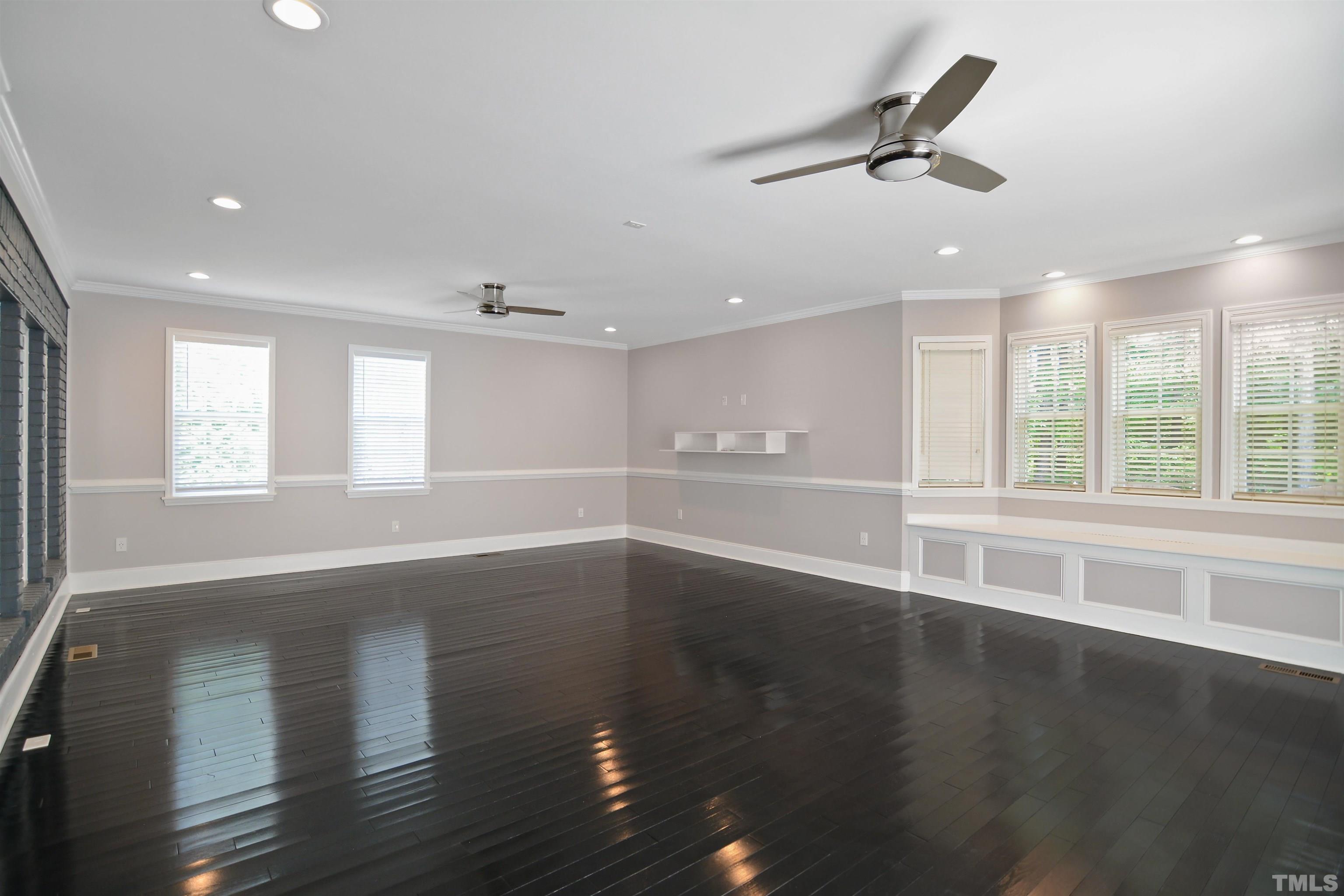 900 Tanworth Drive Raleigh, NC 27615 - Photo 10 of 26 an empty room with wooden floor and windows