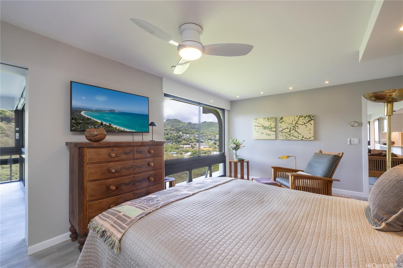 1022 Prospect Street, Unit 903E Honolulu, HI 96813 - Photo 13 of 25 a bedroom with a bed and wooden floor