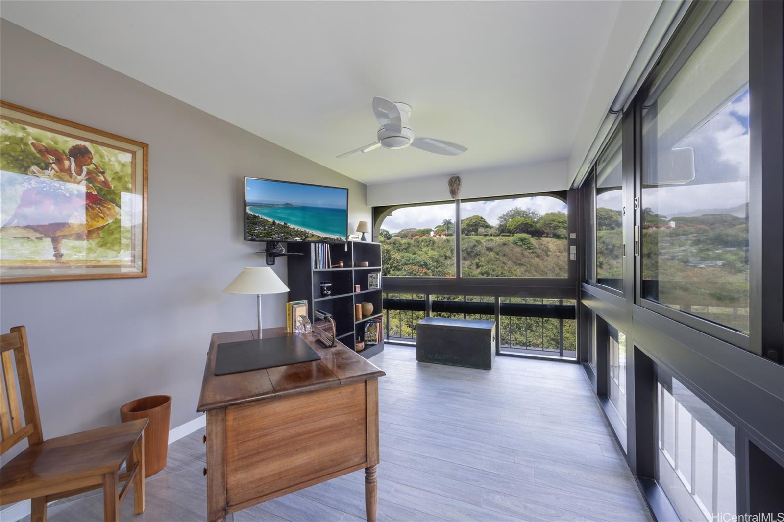 1022 Prospect Street, Unit 903E Honolulu, HI 96813 - Photo 16 of 25 a living room with furniture a flat screen tv and floor to ceiling windows