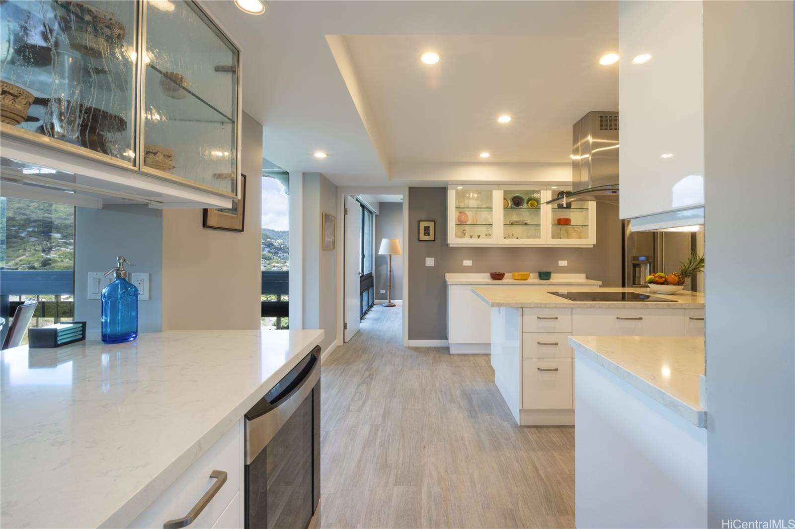 1022 Prospect Street, Unit 903E Honolulu, HI 96813 - Photo 8 of 25 a large kitchen with kitchen island a sink stainless steel appliances and cabinets