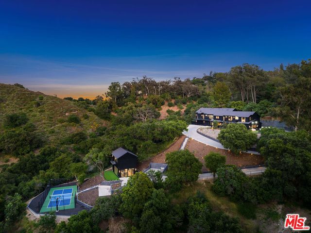 a view of a house with pool and sitting area