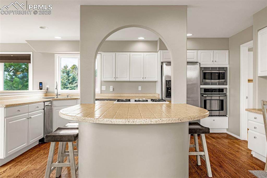18475 Lower Lake Road Monument, CO 80132 - Photo 15 of 50 a kitchen with stainless steel appliances granite countertop a stove a sink and a refrigerator