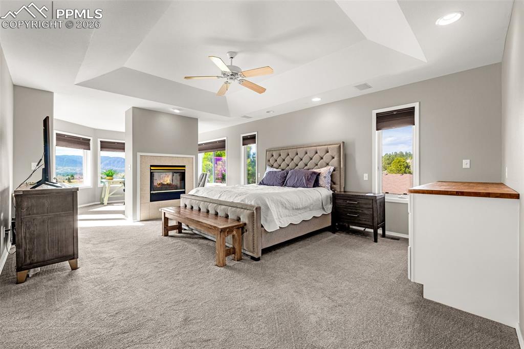 18475 Lower Lake Road Monument, CO 80132 - Photo 19 of 50 a bedroom with a bed and a chandelier