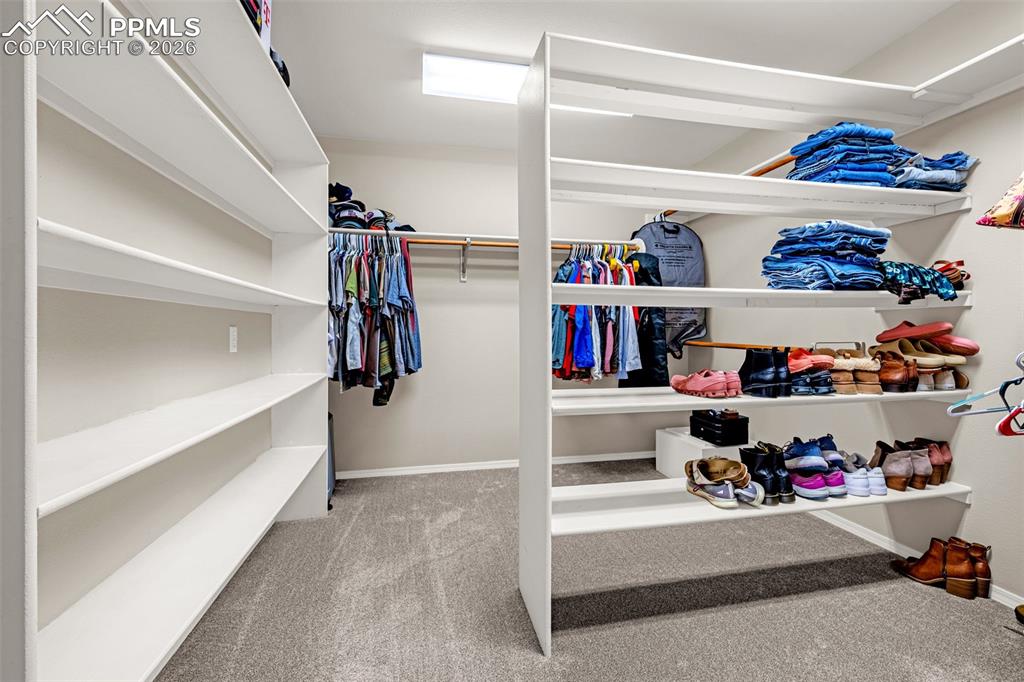 18475 Lower Lake Road Monument, CO 80132 - Photo 25 of 50 a view of walk in closet with clothes and shoes
