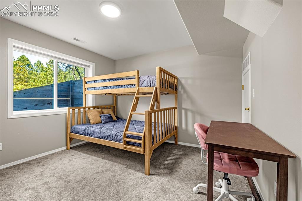 18475 Lower Lake Road Monument, CO 80132 - Photo 36 of 50 a bedroom with a bed and a window