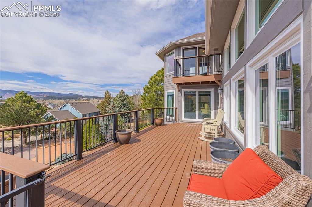 18475 Lower Lake Road Monument, CO 80132 - Photo 7 of 50 a view of a balcony with two chairs and wooden floor