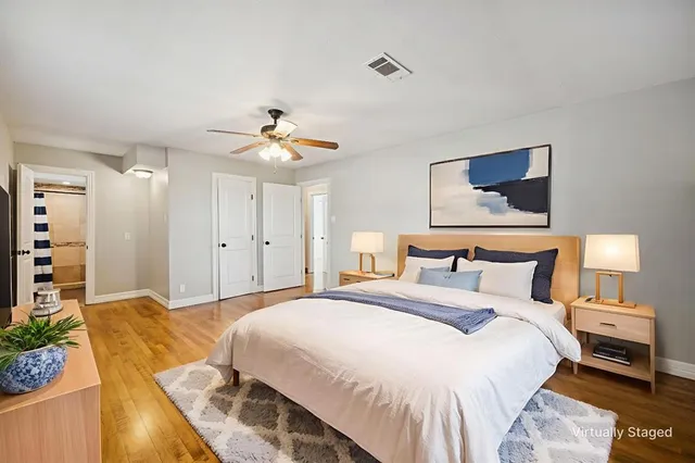 a bedroom with a bed and a chandelier