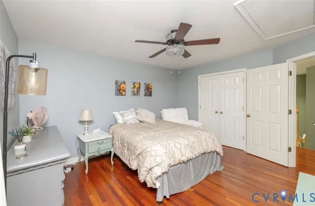 a spacious bedroom with a bed and a chandelier