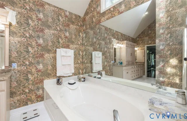 a bathroom with a sink a mirror and a shower