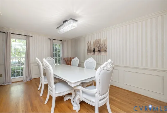 a view of a dining room with furniture and wooden floor