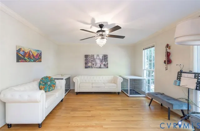 a living room with furniture and a table with wooden floor