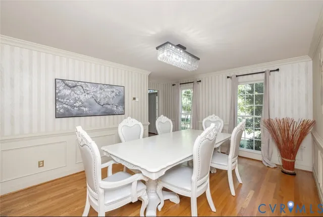 a living room with furniture and a table with wooden floor