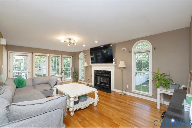 a living room with furniture fireplace and window