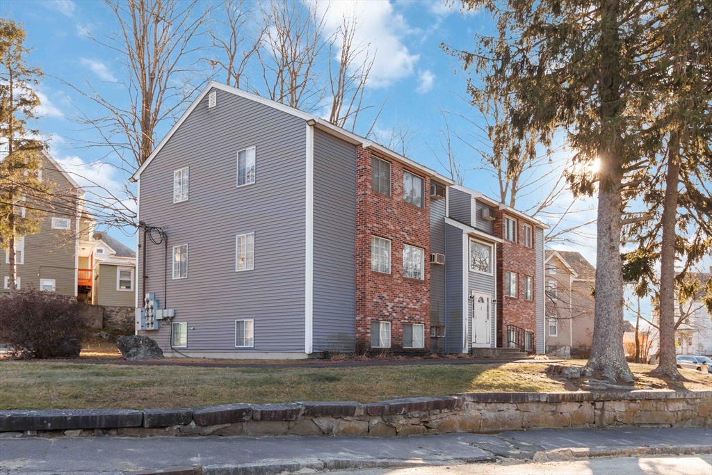 1 19th Street, Unit 3 Lowell, MA 01850 - Photo 1 of 22 a view of a house with a yard