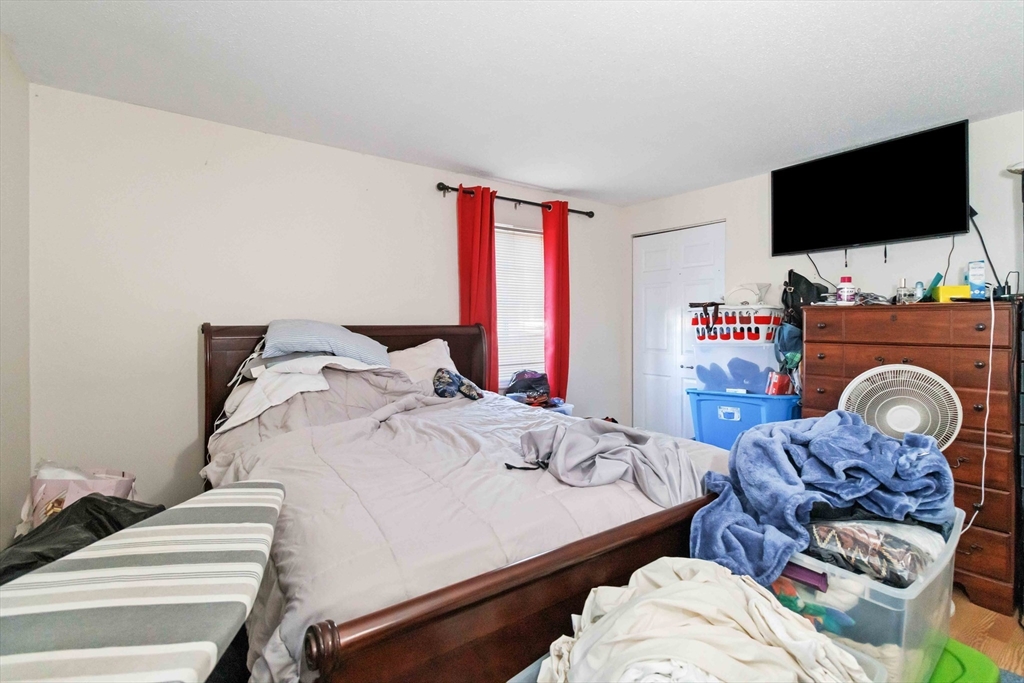1 19th Street, Unit 3 Lowell, MA 01850 - Photo 15 of 22 a bedroom with a bed and a flat screen tv