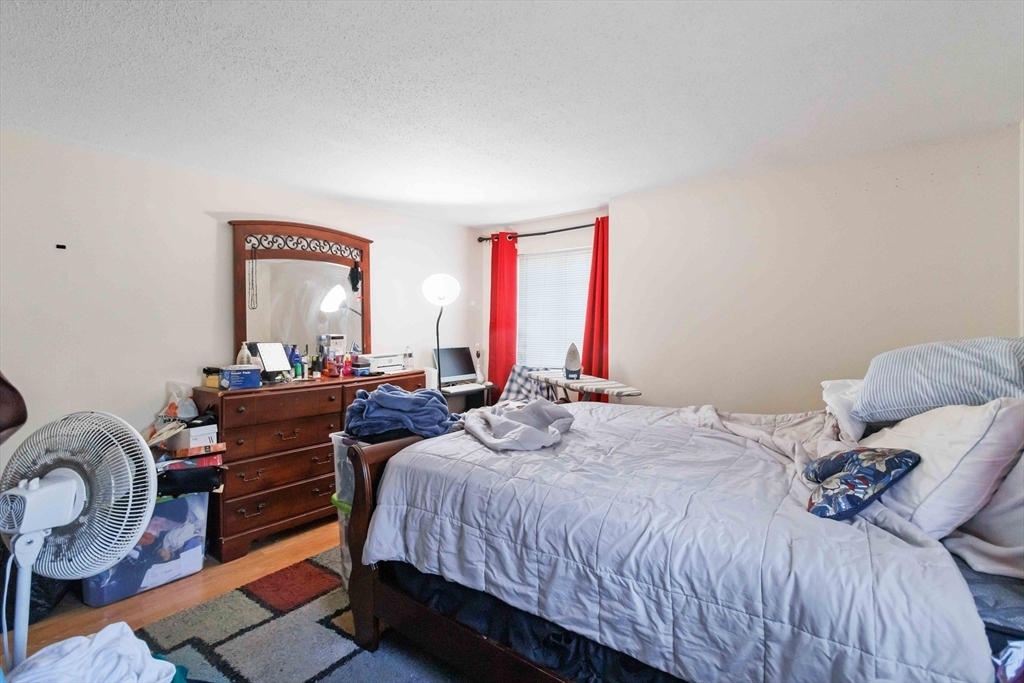 1 19th Street, Unit 3 Lowell, MA 01850 - Photo 16 of 22 a bedroom with a bed and a dresser