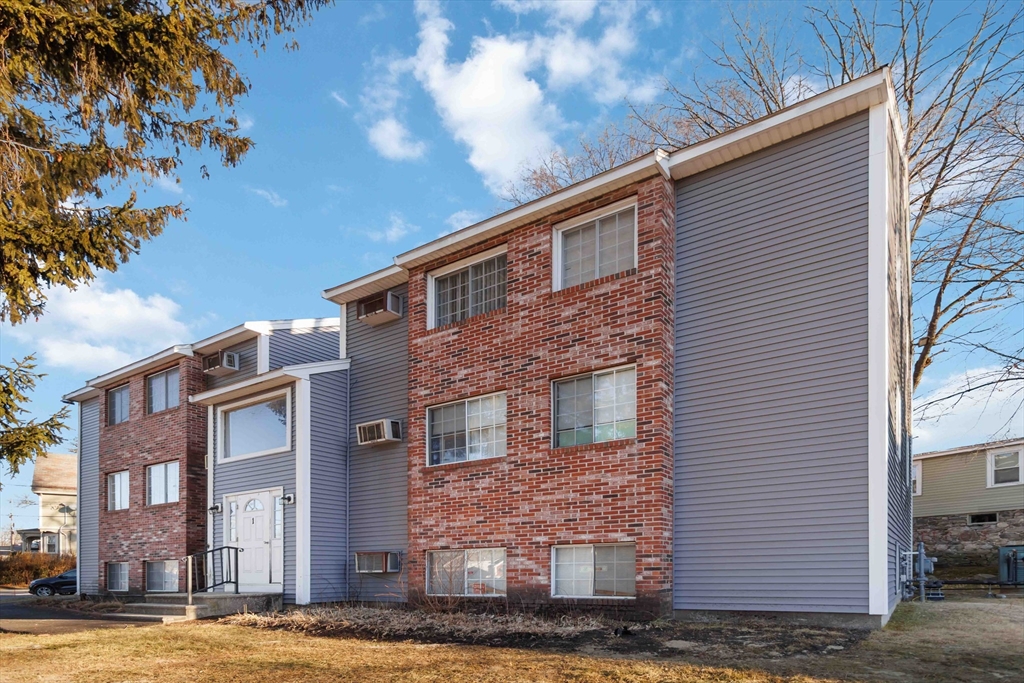 1 19th Street, Unit 3 Lowell, MA 01850 - Photo 2 of 22 a front view of a house with a yard
