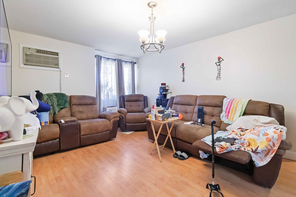 1 19th Street, Unit 3 Lowell, MA 01850 - Photo 4 of 22 a bedroom with furniture and a chandelier