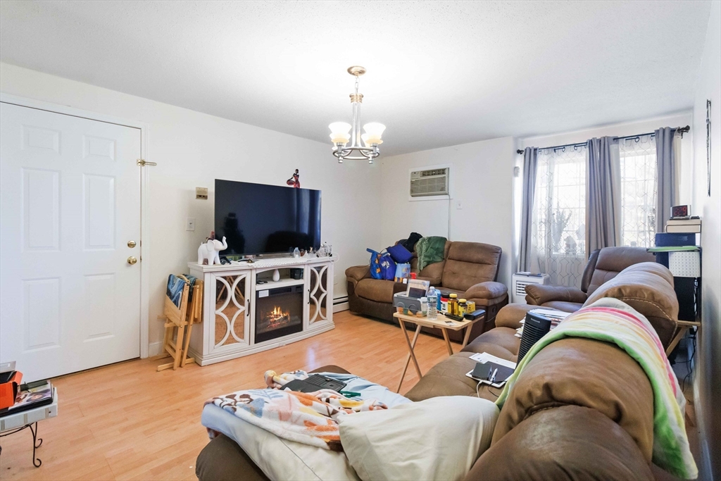1 19th Street, Unit 3 Lowell, MA 01850 - Photo 5 of 22 a living room with furniture and a flat screen tv