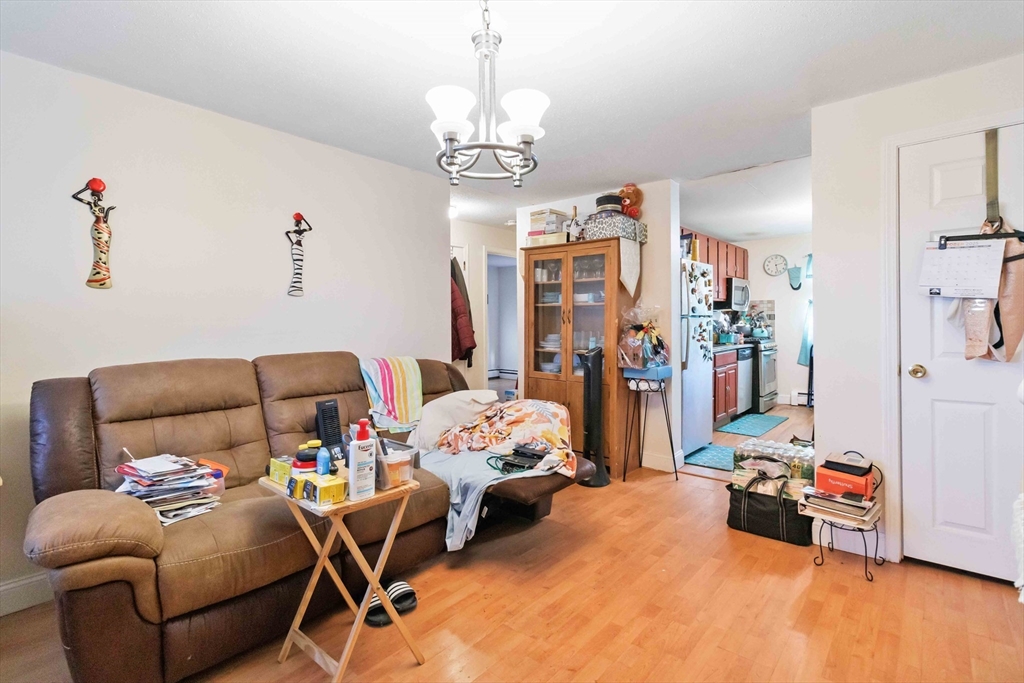 1 19th Street, Unit 3 Lowell, MA 01850 - Photo 7 of 22 a bedroom with furniture and a chandelier