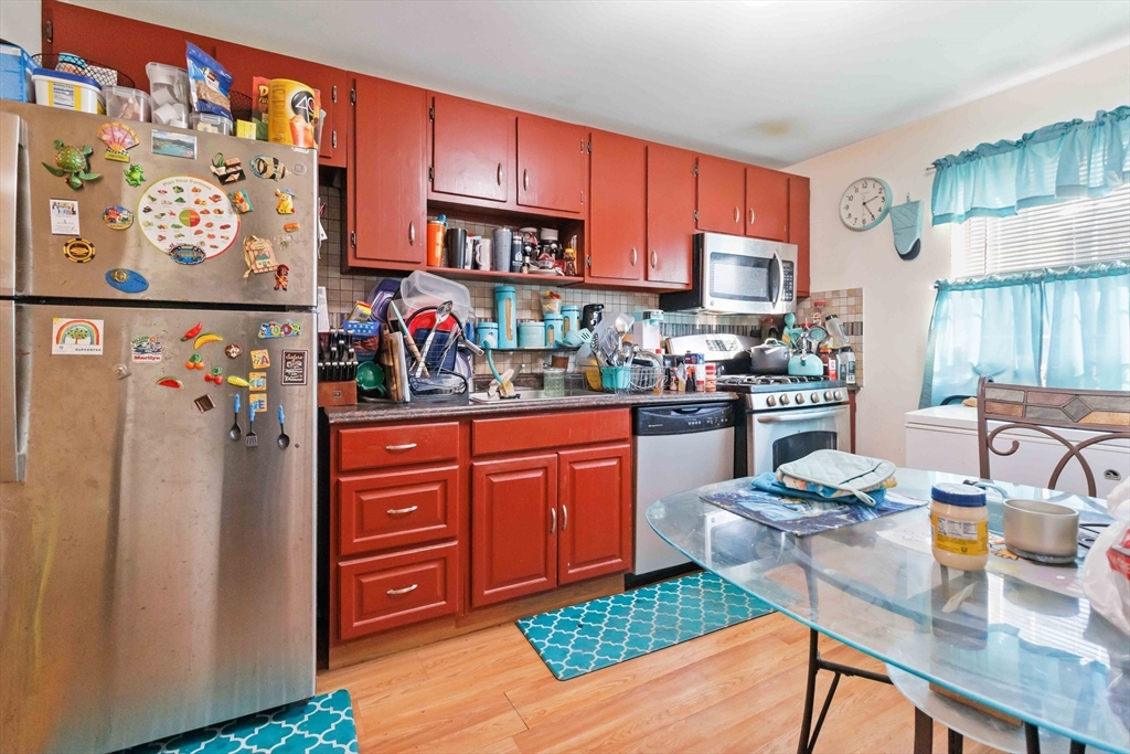 1 19th Street, Unit 3 Lowell, MA 01850 - Photo 10 of 22 a kitchen with stainless steel appliances granite countertop a refrigerator and a stove top oven
