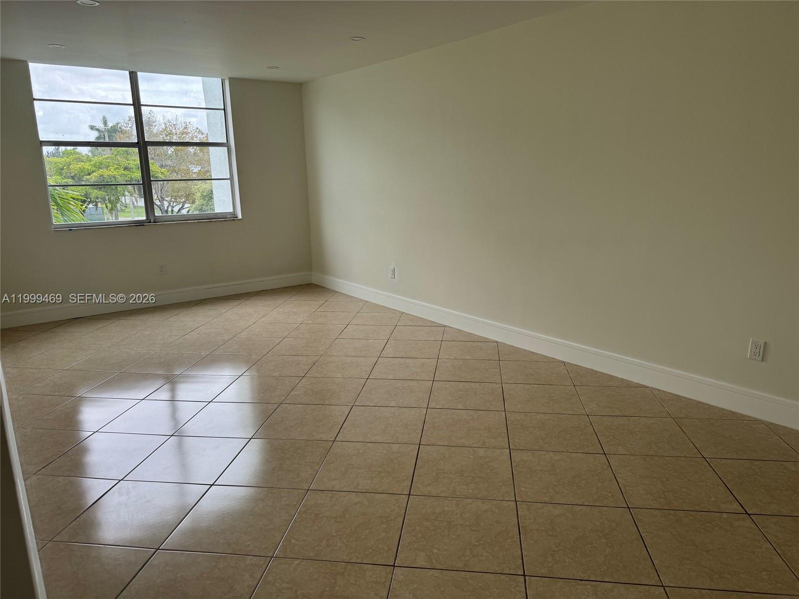 492 Northwest 165th Street, Unit C309 Miami, FL 33169 - Photo 11 of 15 a view of an empty room with a window