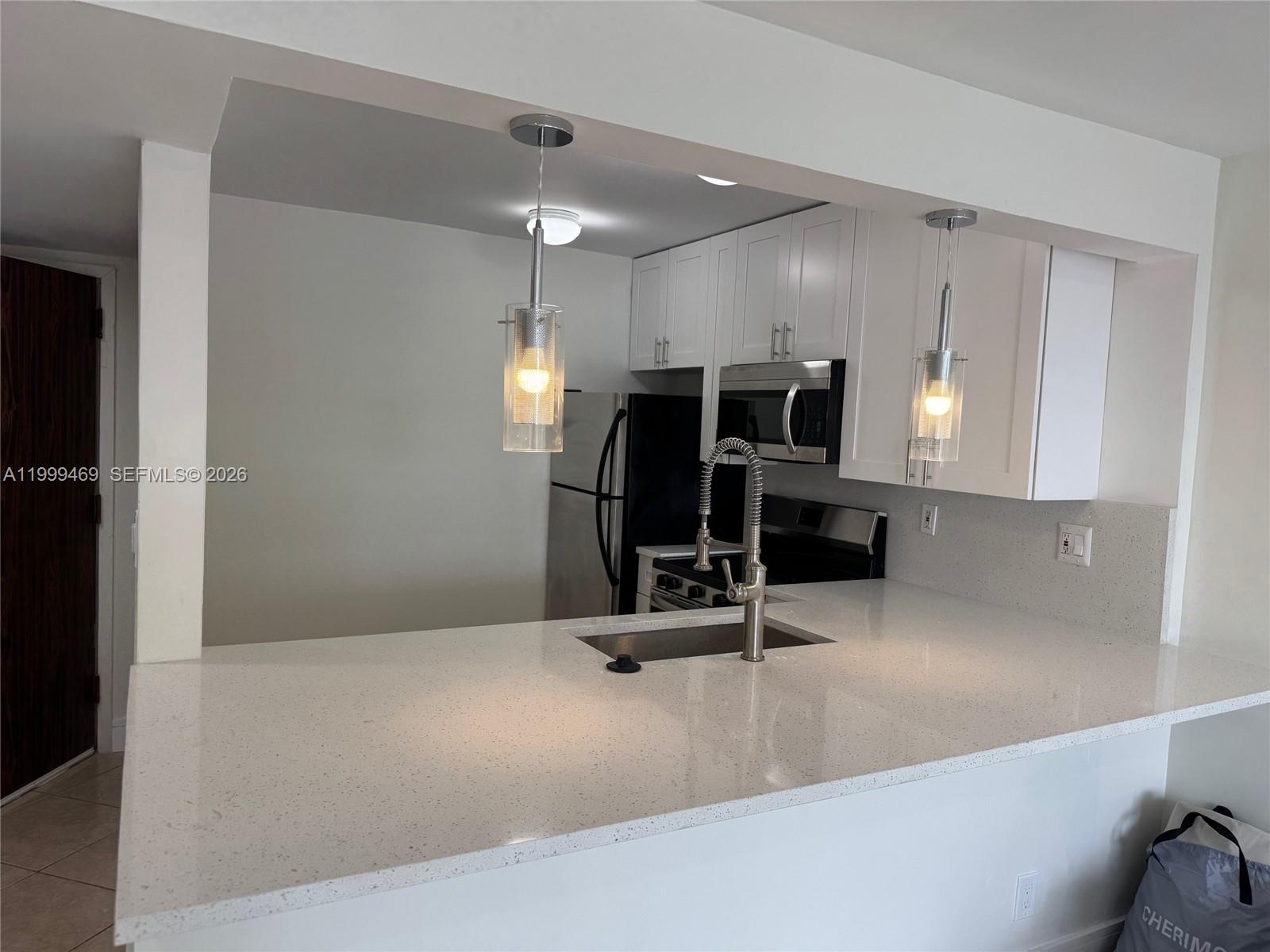 492 Northwest 165th Street, Unit C309 Miami, FL 33169 - Photo 2 of 15 a view of a living room with gym equipment