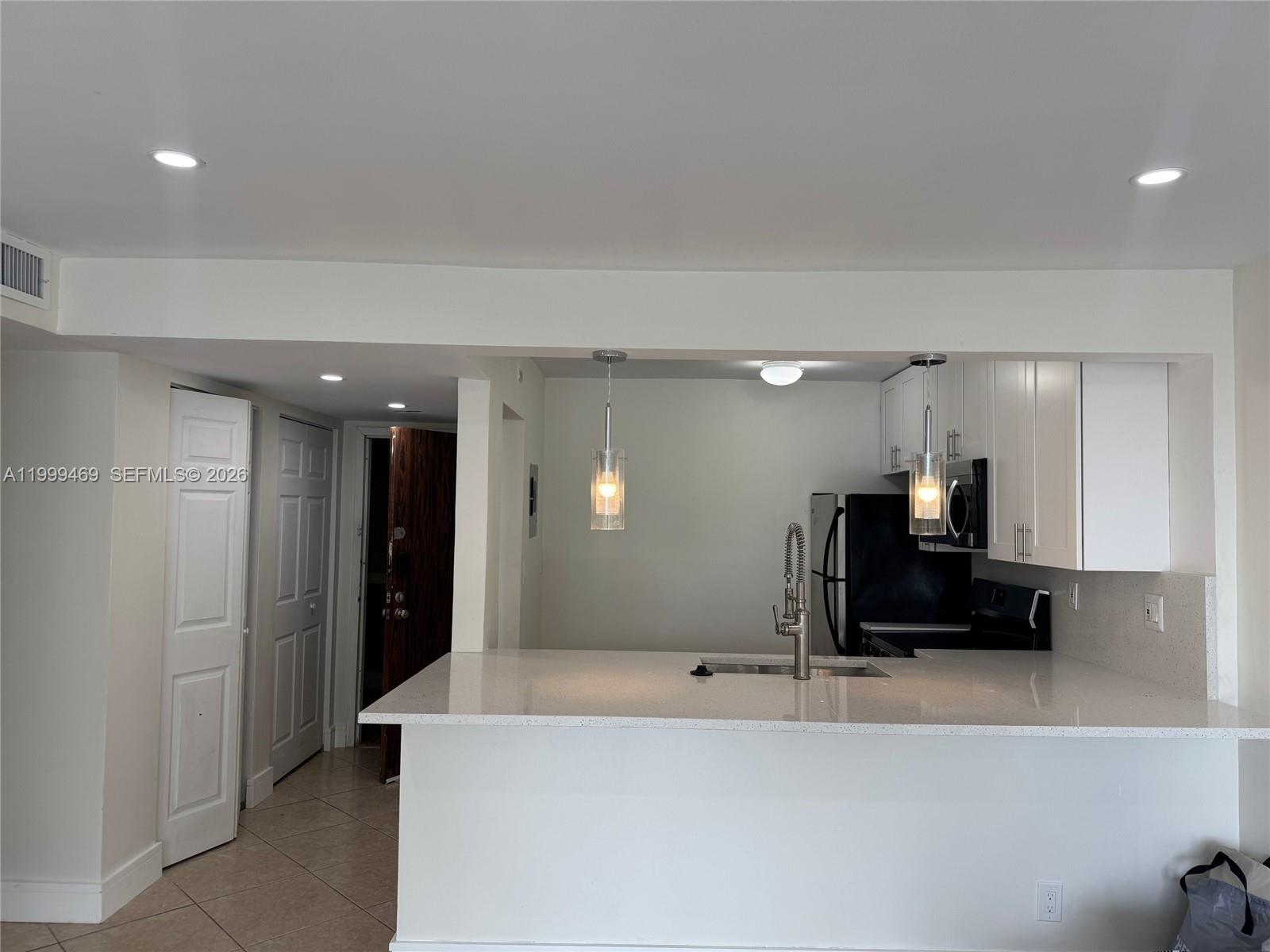 492 Northwest 165th Street, Unit C309 Miami, FL 33169 - Photo 3 of 15 a living room with furniture and a mirror