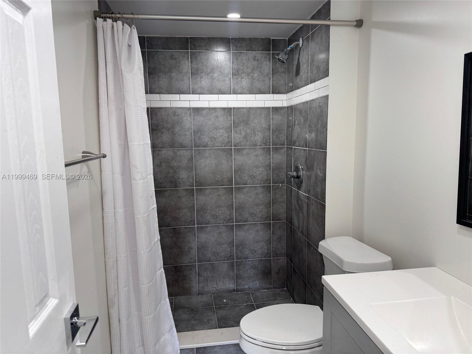 492 Northwest 165th Street, Unit C309 Miami, FL 33169 - Photo 8 of 15 a bathroom with a shower and toilet