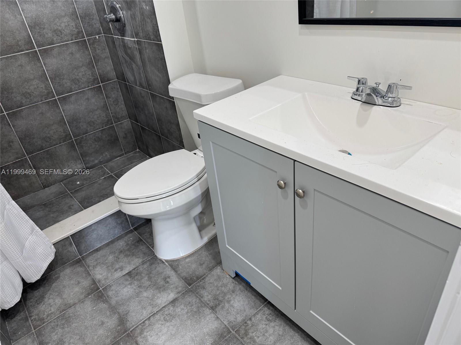 492 Northwest 165th Street, Unit C309 Miami, FL 33169 - Photo 10 of 15 a bathroom with a sink a toilet and shower