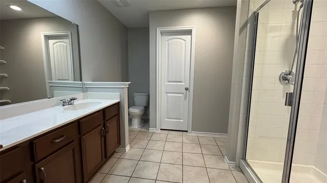 a spacious bathroom with a mirror a vanity and a shower