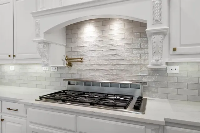 a stove top oven sitting inside of a kitchen