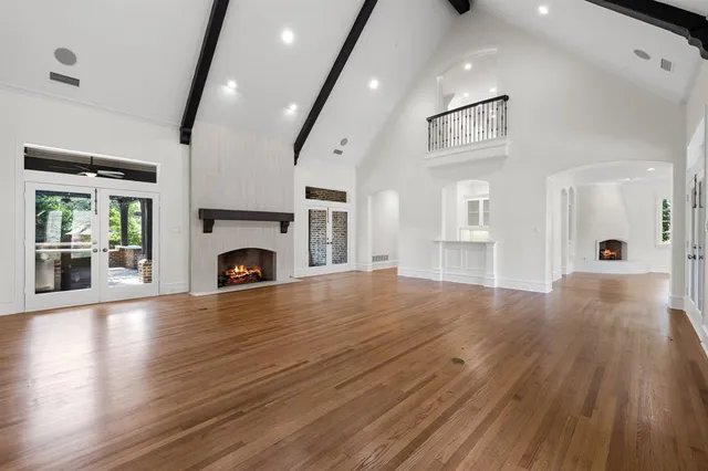 a view of empty room with wooden floor and fireplace