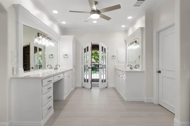 a large bathroom with a large mirror vanity and shower