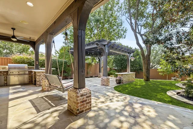 a view of a patio with couches chairs and a big yard