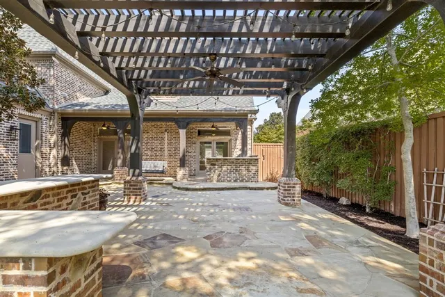 a view of a porch with furniture and wooden fence